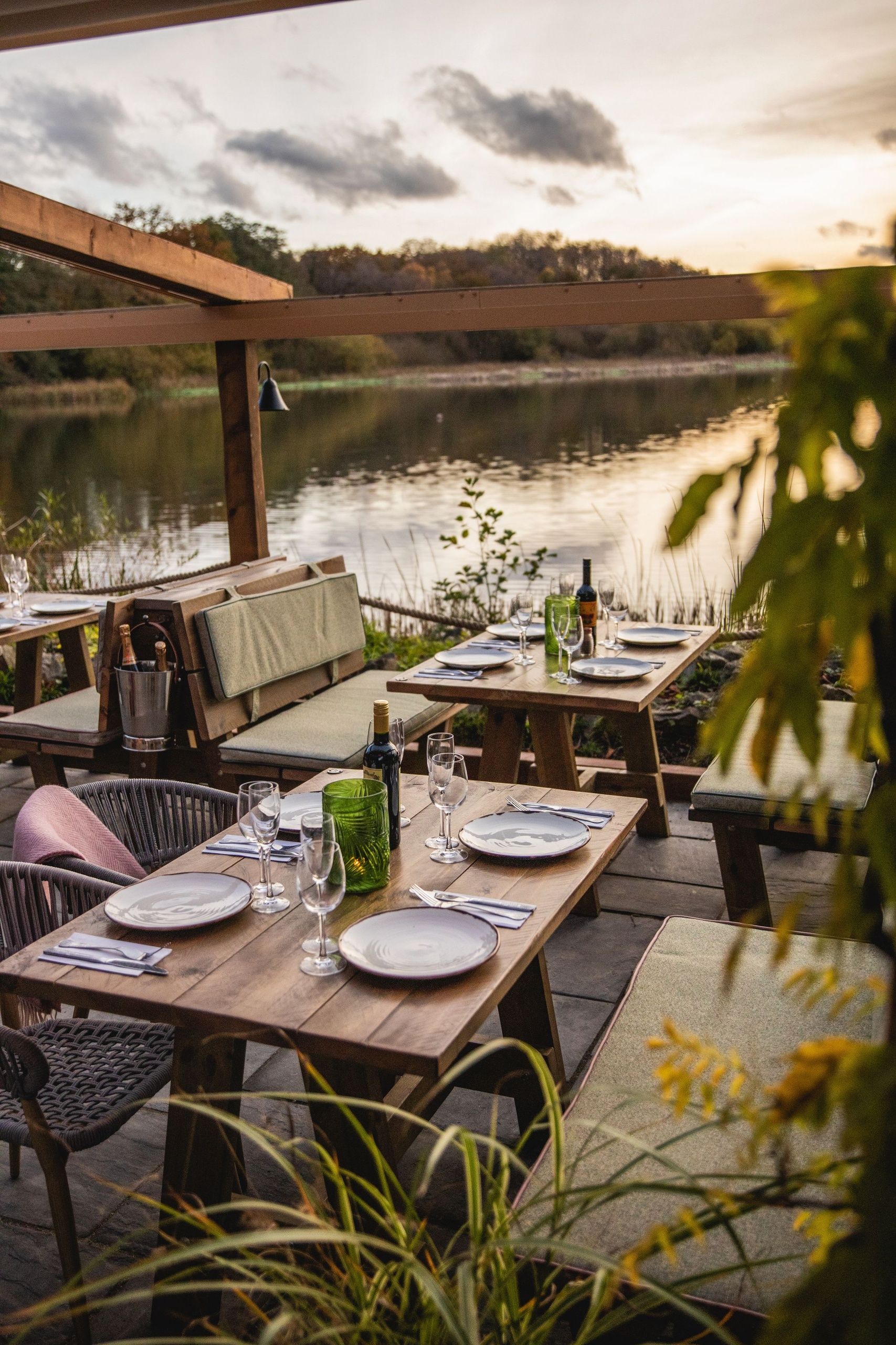 Sunny table setting on lakewide terrace at sunset